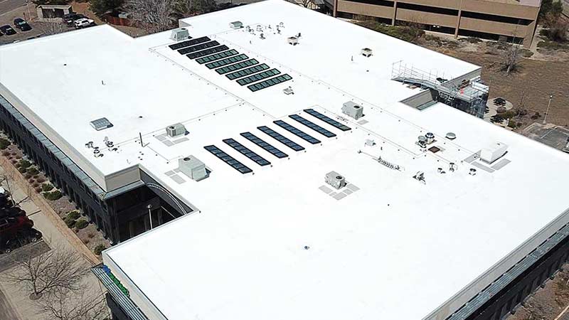 An aerial view of a completed college commercial roofing project by Vertical Roofing