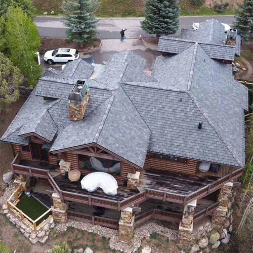 An aerial photo of a Vertical Roofing project - a 2 story residential home in the mountains of Colorado.