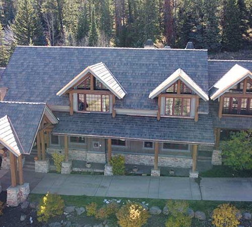 An aerial view of a completed residential roofing project by Vertical Roofing in the mountains of Colorado.