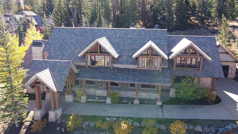 An aerial view of a completed residential roofing project by Vertical Roofing in the mountains of Colorado.