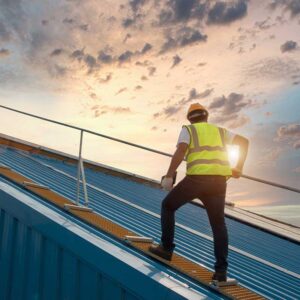 Roofer inspecting commercial building