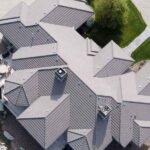 Standing seam metal roof installation on custom residential home