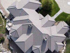 Standing seam metal roof installation on custom residential home